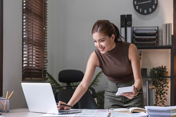 Business woman using calculator for do math finance on wooden desk in office and business working background, tax, accounting, statistics and analytic research concept.