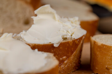 fresh soft cheese made from cow's milk spread on wheat bread