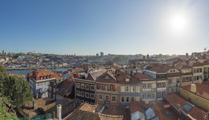 Fototapeta na wymiar Aerial view from one of the viewpoints of the city with the details of the unique buildings of the historic center of the city of Porto and Douro river, Portugal