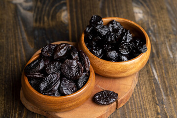 Black pile of prunes from a large number of ripe plums