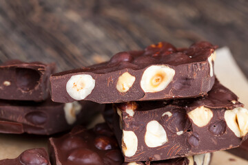 Pieces of homemade milk chocolate with lots of hazelnuts