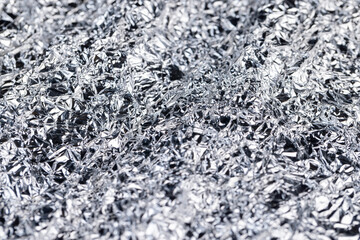crumpled thin aluminum foil reflecting light