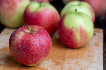 Naklejka na ściany i meble Fresh red and green apples on the kitchen table