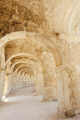 A photo of the upper balcony walkway and arches in Aspendos ancient theater, emphasizing its architectural beauty and scale.