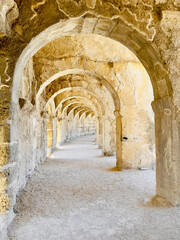 A photo of the upper balcony walkway and arches in Aspendos ancient theater, emphasizing its architectural beauty and scale.