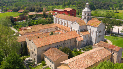 Fototapeta na wymiar Aerial view of Fossanova Abbey located in Priverno, in the province of Latina, Italy. The church is a national monument and a perfect example of the transition from Romanesque to Italian Gothic.