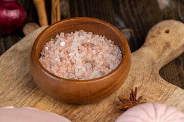 Pink natural salt on the table, close up