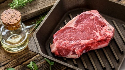 Sizzling Temptation: Top-View Close-up of Raw Steak on a Cast Iron Pan, Ready for Cooking