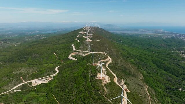 wind generators spinning on the ridge in mountains, summer sunny day, Aerial view, Ulcinj city in Montenegro