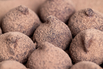 a large number of sweet candies in chocolate powder