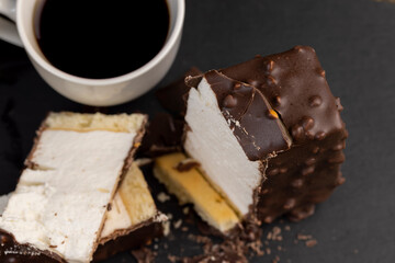 Fresh sweet cake with milk taste and aroma in chocolate glaze