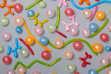 Multicolored balloons on gray wall festive background decoration for children events holiday birthday.