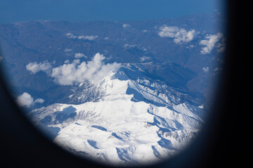 snow covered Himalayas from for a window seat on an aeroplane.