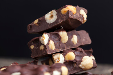 Pieces of homemade milk chocolate with lots of hazelnuts