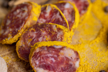 Sliced pork salami with spices and lots of turmeric
