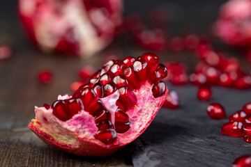 Grains of red ripe pomegranate close up