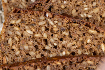 Black rye bread cut into chunks with sunflower seeds