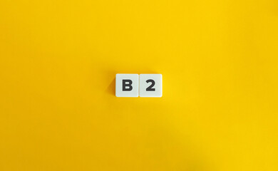 B2 level of language proficiency. Block Letter Tiles on Yellow Background. Minimal Aesthetics.