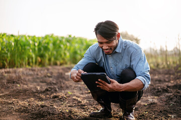 Smart farmer using digital tablet to examining quality of soil f
