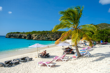 Grote Knip Beach Curacao Island March 2021, Tropical beach on the Caribbean island of Curacao Caribbean with tourist sunbathing under umbrellas at beach chairs on the beach