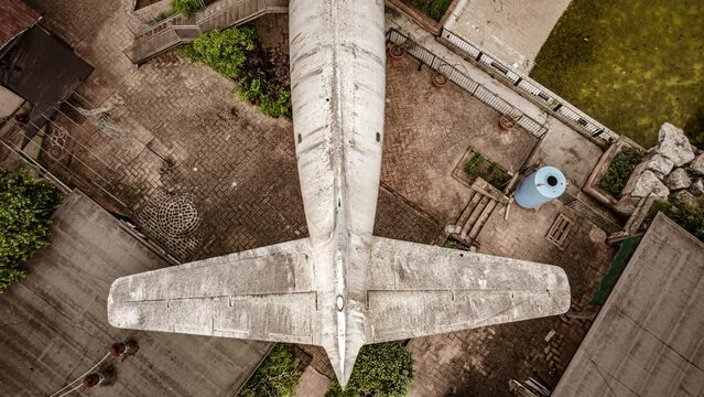 Aerial Close-up of Decaying Abandoned Airplane Tail