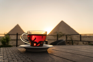 glass mug with tea on beautiful background of the main attractions of Egypt, the Great pyramids of...