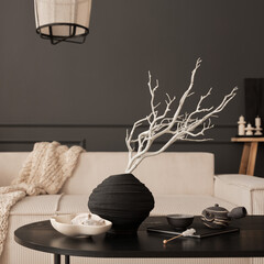 Interior design of elegant living room with modular sofa, round pillow, plaid, vase with dried...
