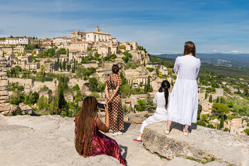 Tourist women enjoying the view of the beautiful medieval village of Gordes, Provence, France