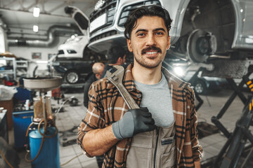 Fototapeta na wymiar Portrait of a male mechanic in an auto repair shop