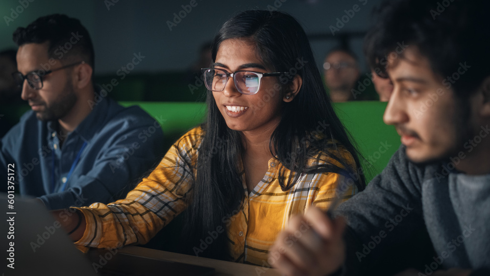 Poster Group of Diverse Happy Students Having a Conversation in University Classroom, Working on a Shared Research Project on a Laptop Computer. Classmates Working Together on College Homework
