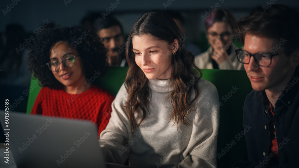 Poster Group of Diverse Happy Students Having a Conversation in University Classroom, Working on a Shared Research Project on a Laptop Computer. Classmates Working Together on College Homework