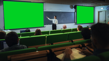 Young Female Teacher Giving a Lecture, Showing Slides on a Green Screen Mock Up Display to a...