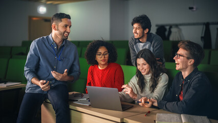 Diverse Happy Students Having a Conversation with a Teacher in University Classroom, Working on a...