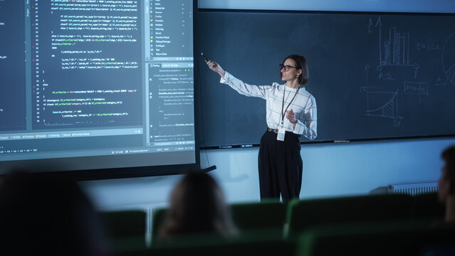 Portrait of a Young University Professor Explaining the Importance of Artificial Intelligence to a Group of Diverse Students. Female Teacher Showing Big Data Ecosystem on a Big Screen