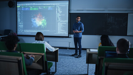 Young Male Teacher Giving a Data Science Lecture to a Diverse Multiethnic Group of Female and Male...