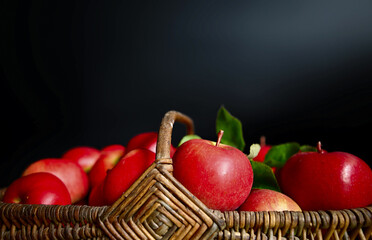 Fototapeta na wymiar - red apple in basket on black background, macro
