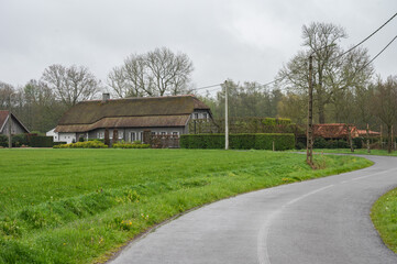 Bending road through the agriculture fields and farms, Geel, Belgium