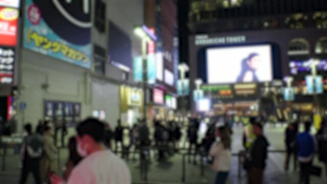 SHINJUKU, TOKYO, JAPAN - APRIL 2023 : KABUKICHO, TOYOKO area at night. TOYOKO KIDS (Group of young people, living around Kabukicho after been kicked out or driven from their homes) at the street.