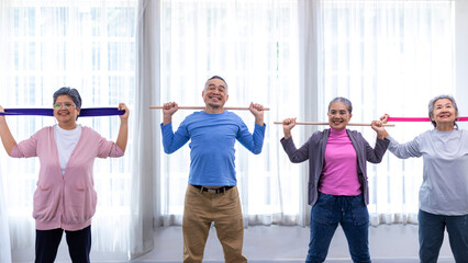 Seniors  stretching exercise together at retirement center. Old people exercise at home. Retired Person exercising at nursing home. Active seniors exercising in home. Sport and recreation concept.