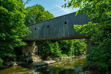 One lane wooden bridge crossing river