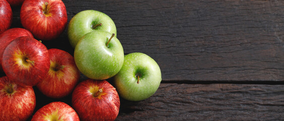 fresh red and green apples on the wooden floor