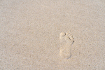 Footprints in sand at beach