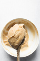 Churros dough on a wooden spoon, choux pastry dough about to be fried, process of making churros