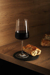 A glass of wine with bread in minimalistic style