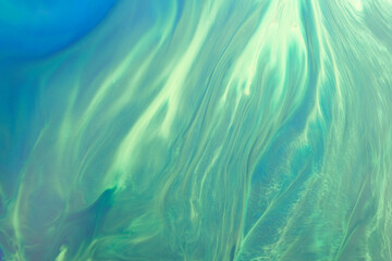Abstract green color background. Multicolored fluid art. Waves, splashes and blots acrylic alcohol ink, paints under water