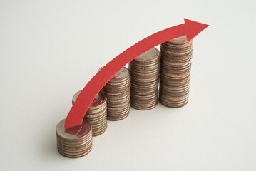 Stack of coins bar chart and red curve graph growing up with white background copy space. Business financial, successful investment, money saving increase, retirement planning, business growing