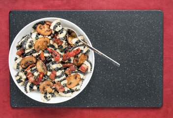 Bowl of Black and White Bow Tie Pasta with Mushrooms and Tomatoes