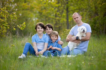 Naklejka na ściany i meble Beautiful family in the park, taking family portrait pictures