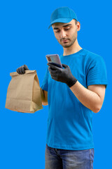 Delivery man with smartphone, gloves, paper bag. Courier in uniform t-shirt service fast delivering orders. Young guy holding a cardboard package. Character on isolated background