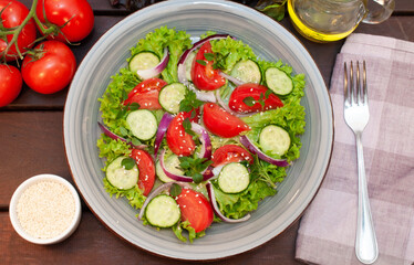 Salad of fresh tomatoes and cucumbers in a bowl